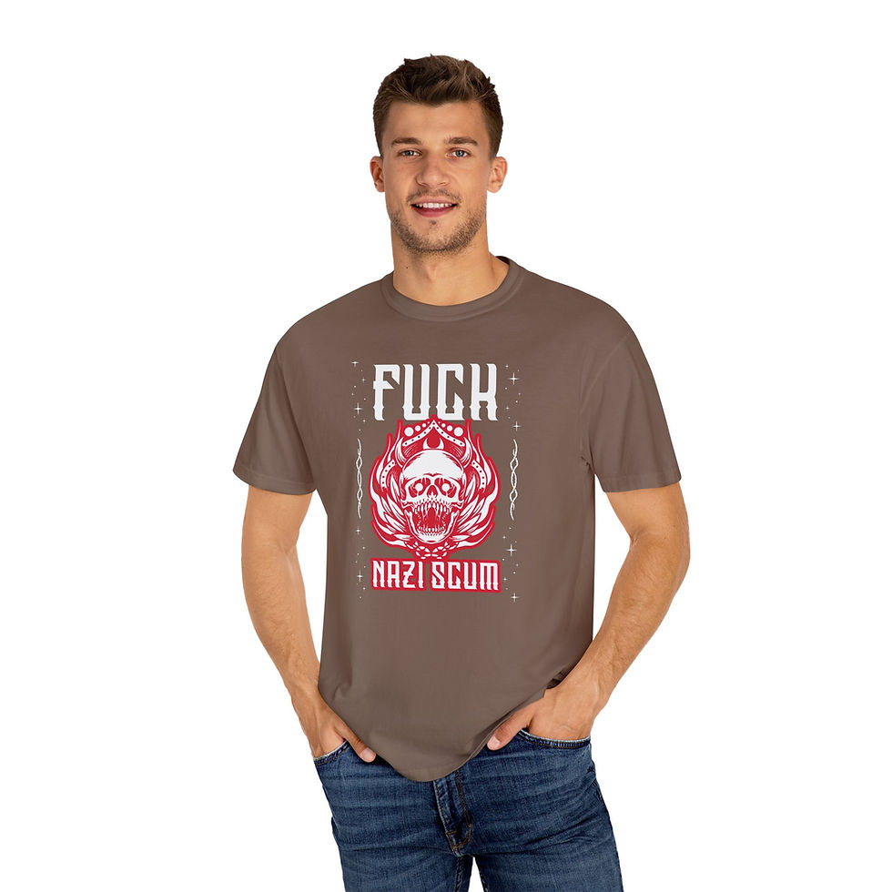 A smiling white man is modelling an espresso-colored T-shirt with a red and white design of an angry red and white skull with an open mouth salivating, and around it are flames. Above the red skull it says "Fuck" in white and letters, and under the skull it says "Nazi Scum" in white lettering with red outlines.