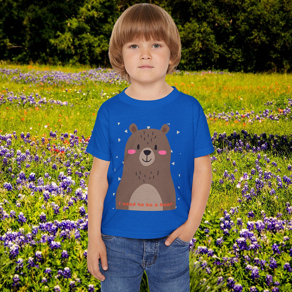 Young boy in blue bear shirt smiles in a flower field. My Site 1