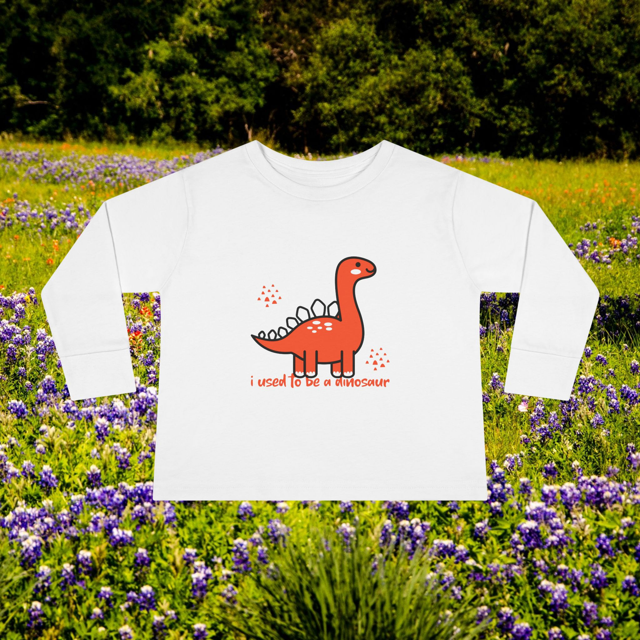 White long sleeve shirt with a red dinosaur and text that says, I used to be a dinosaur.