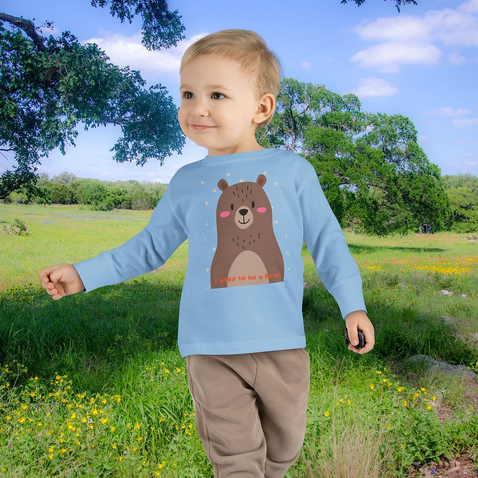 Thumbnail: Young kid in blue shirt with a bear graphic walking in nature.