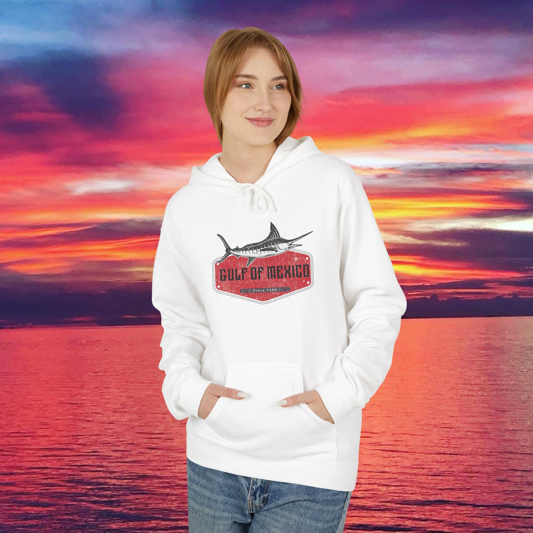 Woman wearing Gulf of Mexico Smiling Swordfish Unisex Heavy Blend™ Hooded Sweatshirt, sunset backdrop My Site 1