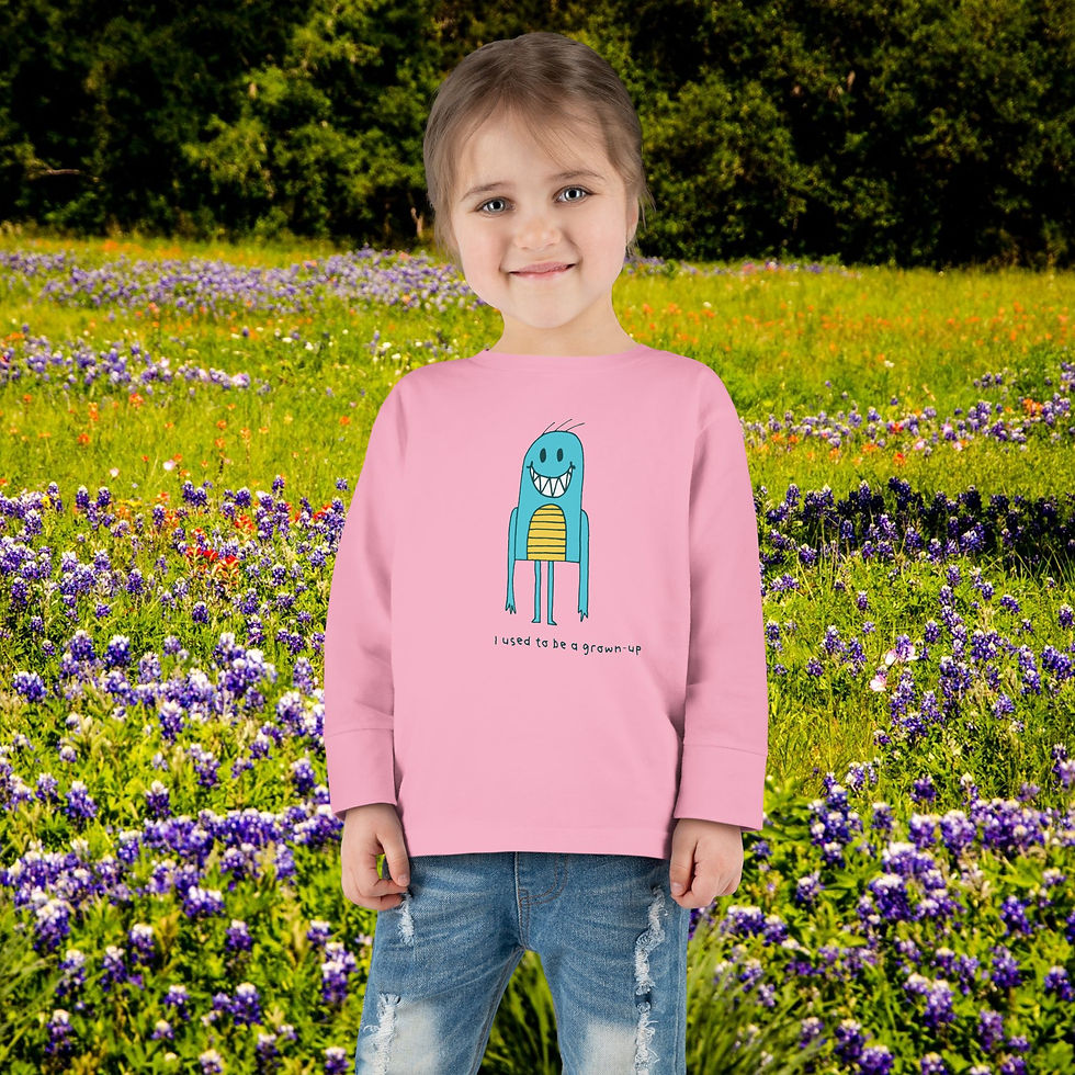 Thumbnail: Young girl in pink shirt with monster graphic smiling in field