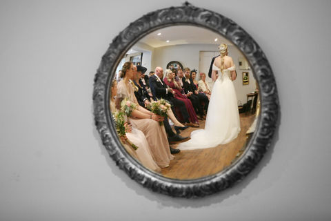 Photograph of a mirror which is reflecting the bride and groom dancing