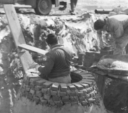 Vintage black and white photograph of Thalle Construction Company works building a masonry style manhole.