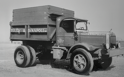 Vintage black and white photo showing one of the earliest work trucks in th Tully & DiNapoli fleet. The truck is labeled as number 54.
