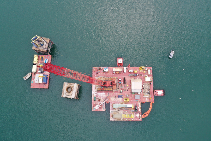 Aerial view of barges supporting crane work activities along Lake Travis, Texas.