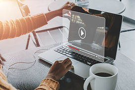 a woman opening a laptop and playing a video