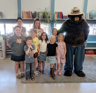 Smokey the Bear visits Mrs. Fretwell's kindergarten through second grade class to teach them about fire safety.