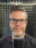 Head shot portrait of Dave Baird in his voiceover studio