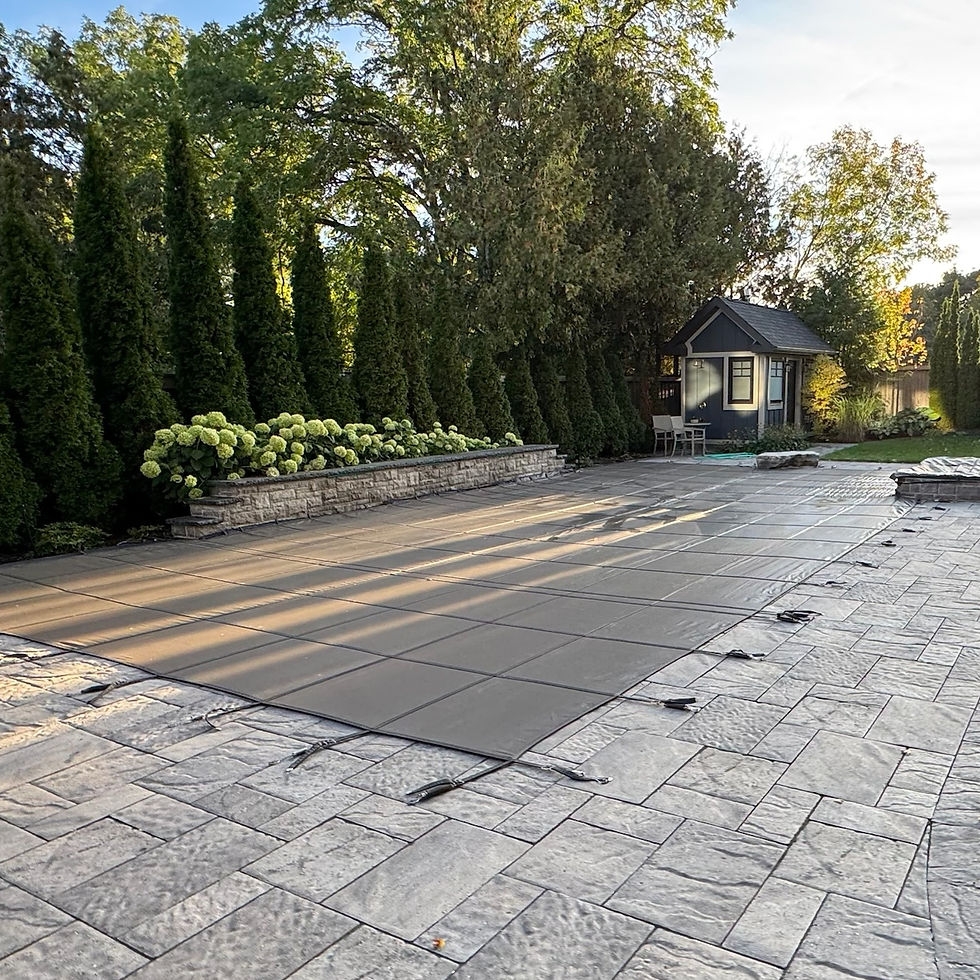 Outdoor pool with safety cover and patio for Pool Services in GTA