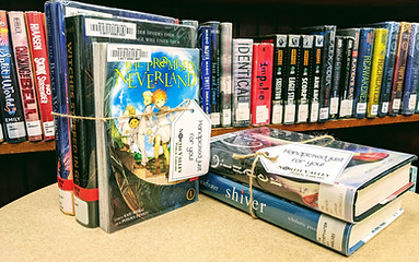 Books bundled in twine with a tag. 