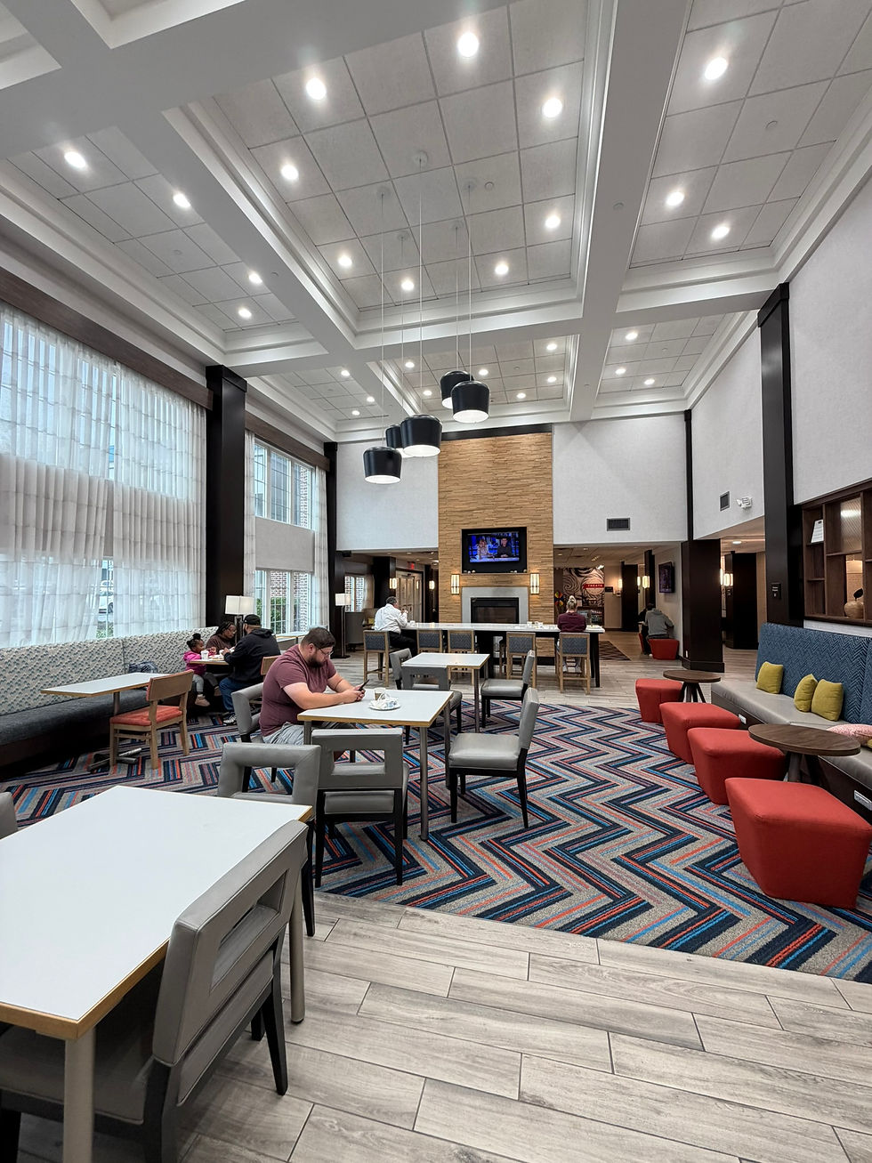 Lobby view of tables and chairs at the Hampton Inn & Suites in Yonkers, New York