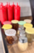 Condiments and pizza spices at The Pizza Block Kosher Restaurant in West Hempstead, New York