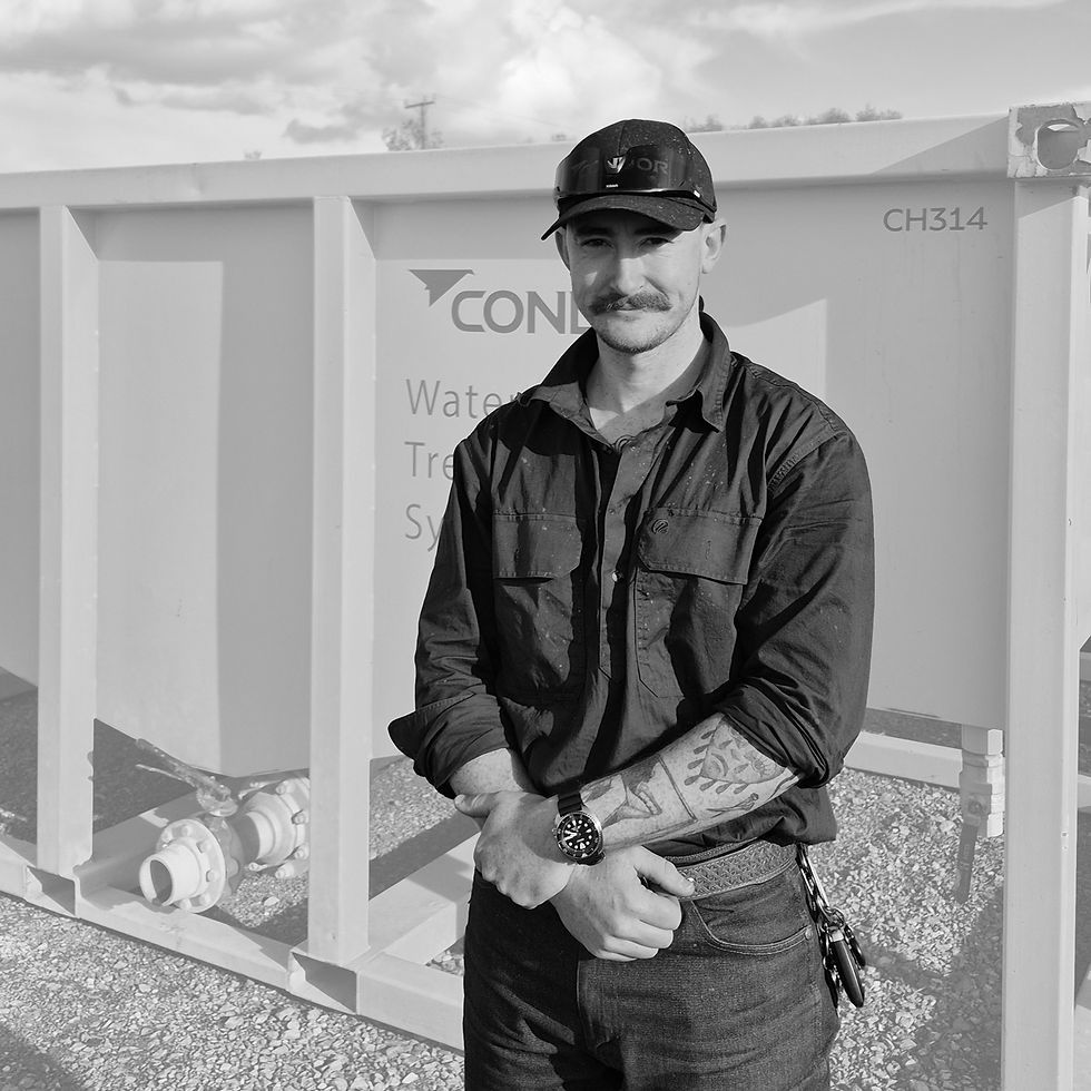 Two construction men talking next to Condor Civil's Water Treatment System