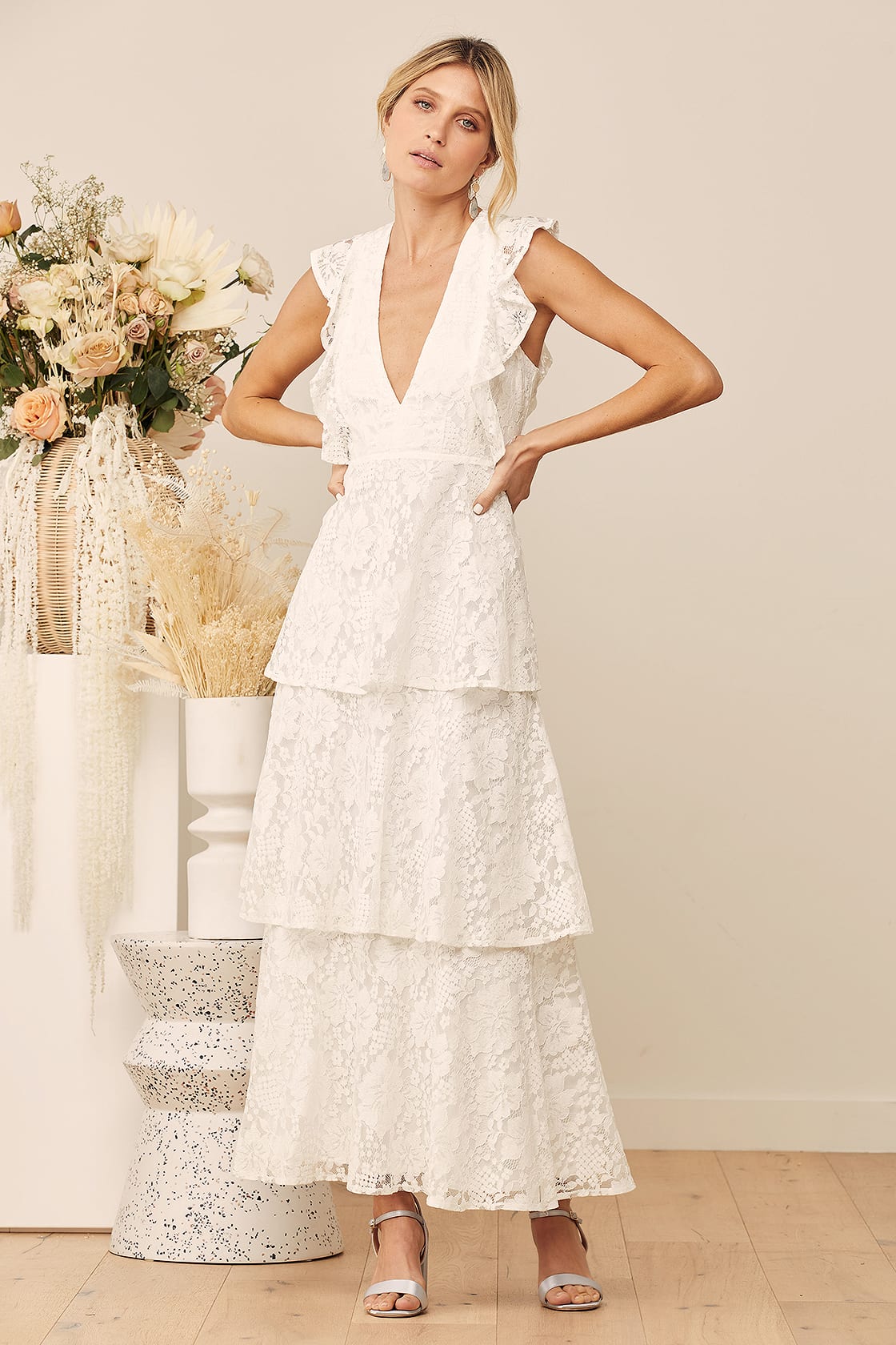 Elegant wedding dress with romantic ruffles, creating a whimsical and ethereal bridal look by Lulu's.