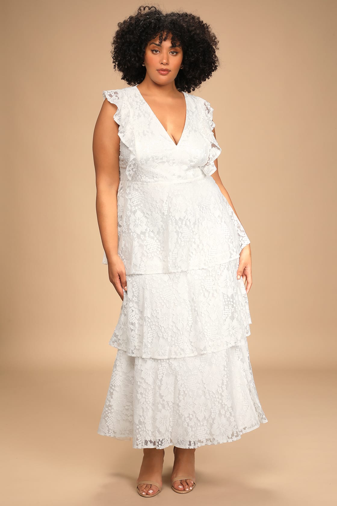 Elegant wedding dress with romantic ruffles, creating a whimsical and ethereal bridal look by Lulu's.