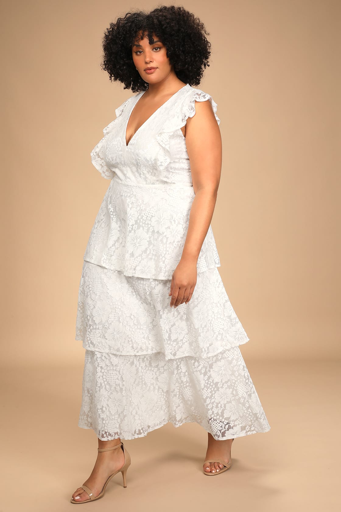 Elegant wedding dress with romantic ruffles, creating a whimsical and ethereal bridal look by Lulu's.