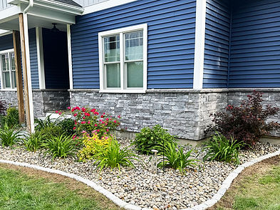 Low-maintenance decorative stone installation for a rock garden and poolside area in Norwell, MA.