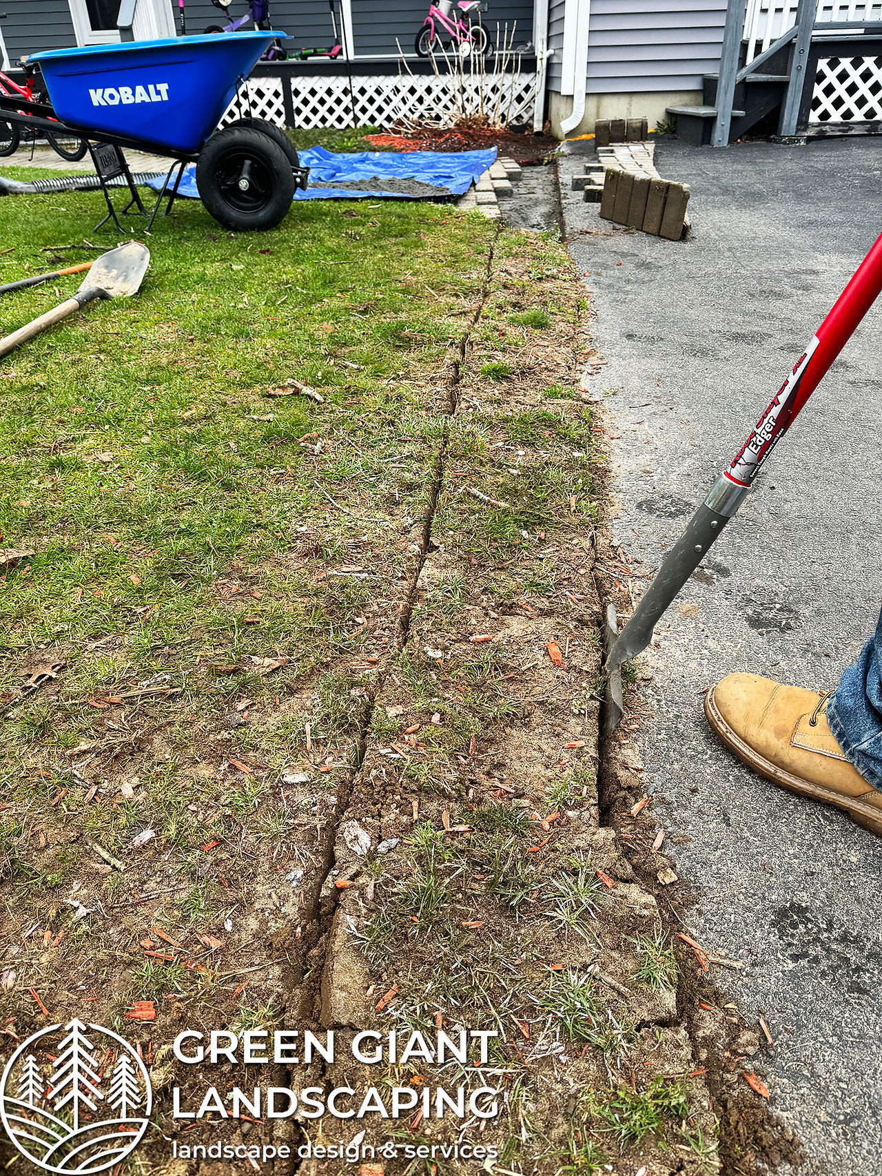 Digging a precise yard drainage trench with a 1 percent pitch slope for water management in Massachusetts.