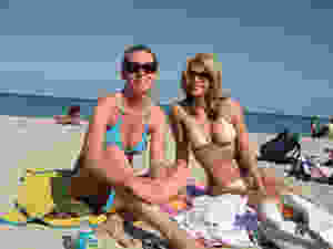 two Canadian women wearing bikinis on the beach in Miami wondering where to buy swimwear online canda