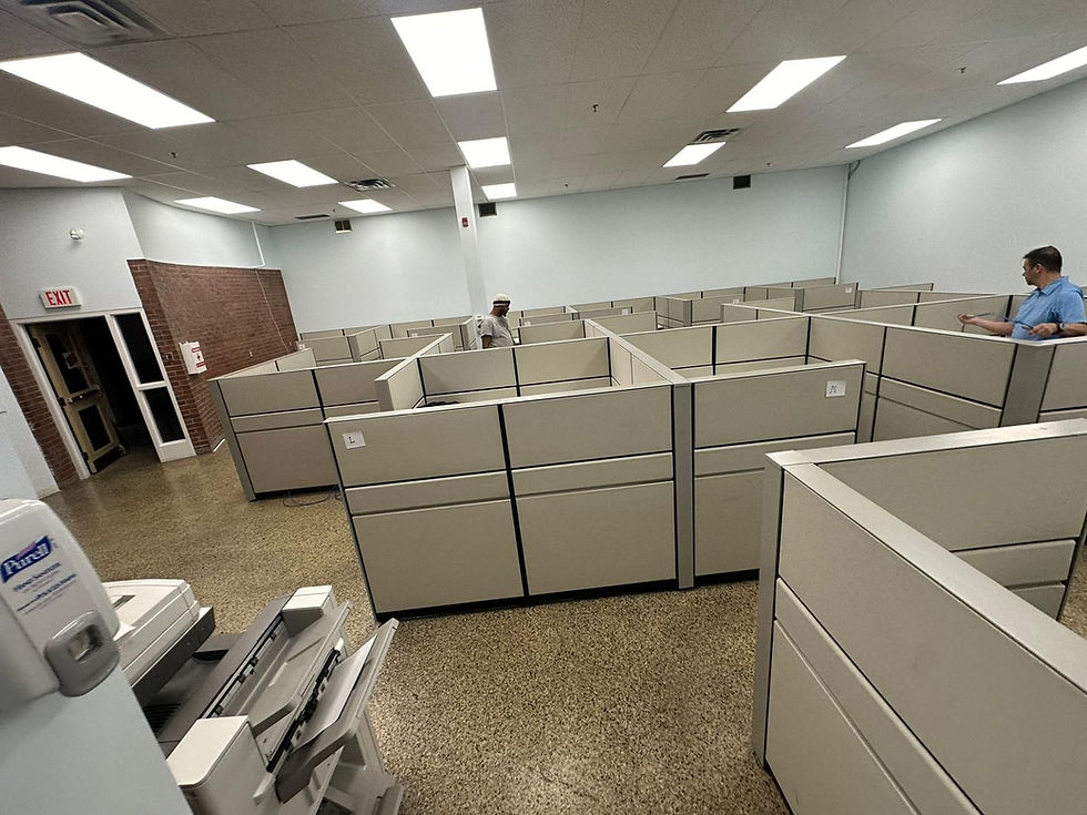 A professional office setting with various types of office furniture from Ufficio Furniture, including ergonomic chairs, desks, and storage units. The space is well-organized, showcasing modern, modular, and stylish designs suitable for different office environments. The furniture pieces are made from materials like wood, metal, and plastic, highlighting the diversity and quality of Ufficio Furniture's offerings. The scene depicts a productive and aesthetically pleasing workspace.