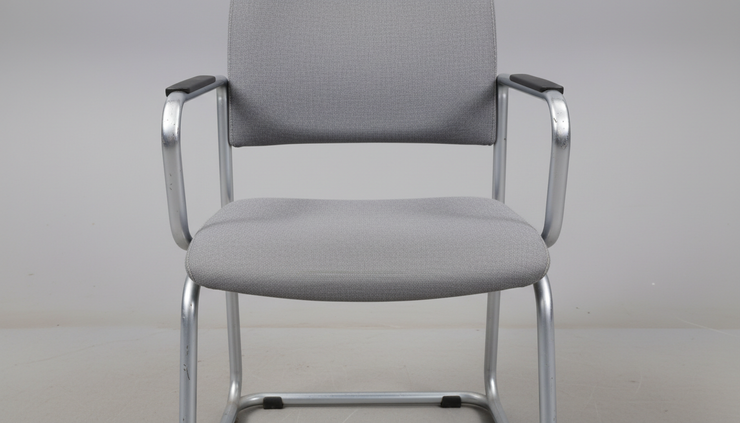 Close-up view of a visitor chair seat and metal frame.