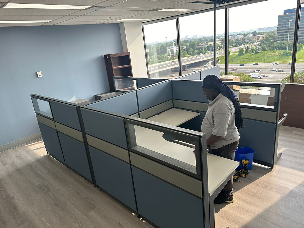 Person assembling an office desk with tools laid out and instructions in hand, ensuring each part is correctly placed and securely fastened."