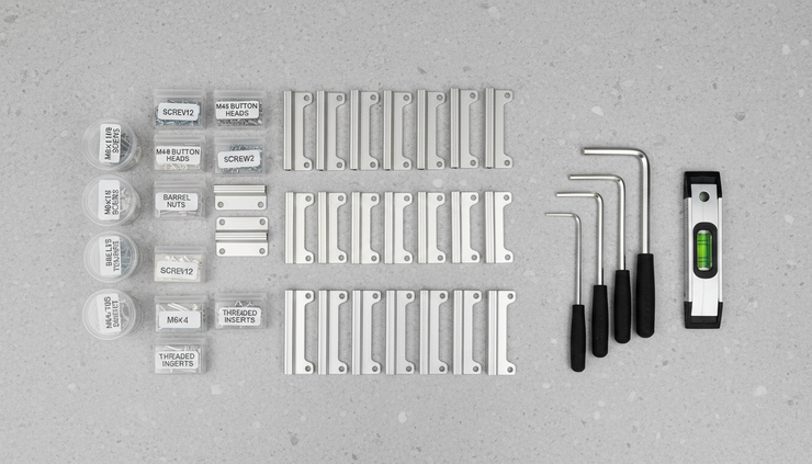 Overhead view of workstation assembly hardware arranged beside a level.