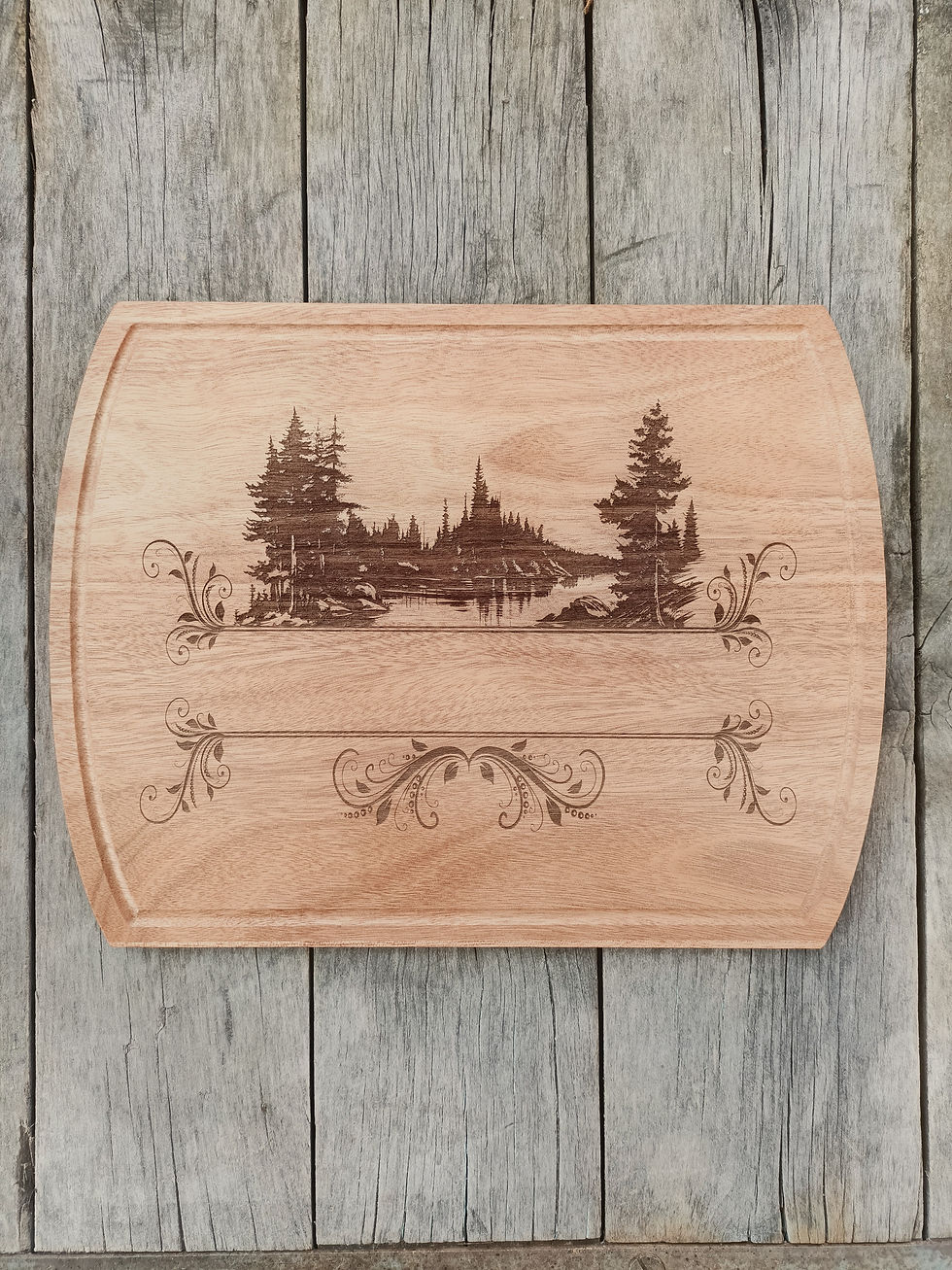 Wooden cutting board with engraved lake and trees design