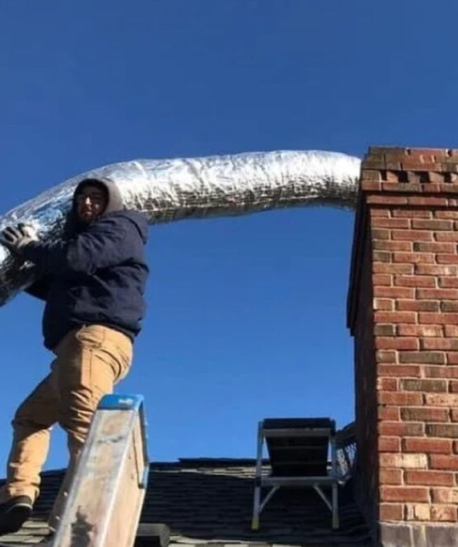 Chimney repair technicians installing new chimney liner
