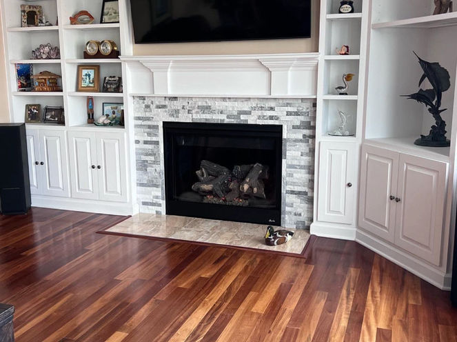 Modern fireplace with stone surround and hardwood floors