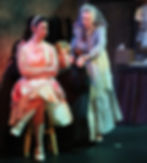 Performers singing and dancing on stage at the Wohlfahrt Haus Dinner Theatre