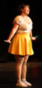 Performer singing and dancing at Wohlfahrt Haus Dinner Theatre