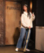 Performer singing and dancing on stage at the Wohlfahrt Haus Dinner Theatre