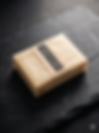 A wrapped Warfighter Wax soap bar on a black slate tablet