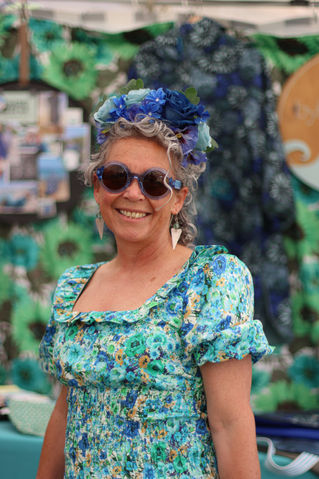 Photo of a female founder selling handmade wild swimming wares at a festival market in Cornwall