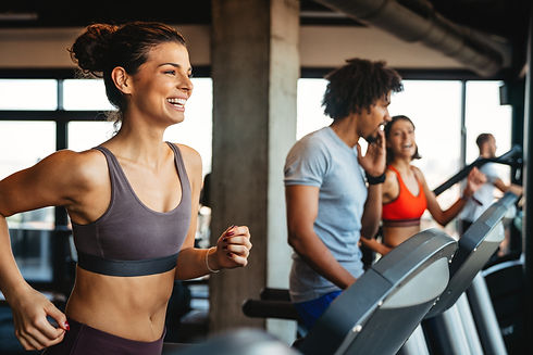 Woman running on treadmill at EP Fitness.