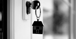 The house key for unlocking a new house is plugged into the door