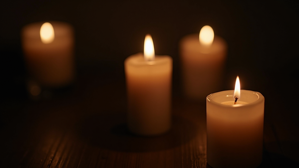 Close-up view of a candle flame flickering in a dark room