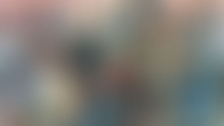 Livros Vikings | Uma ilustração detalhada mostrando um grupo de guerreiros vikings. No centro, um guerreiro veterano com barba branca e elmo de proteção facial proeminente segura um machado de batalha. Ele usa cota de malha e capa de pele. À sua direita, um guerreiro mais jovem segura um escudo azul redondo e lança. Outros guerreiros estão à esquerda. O fundo mostra uma praia com navios viking (langskip) e atividades de desembarque ao pôr do sol.