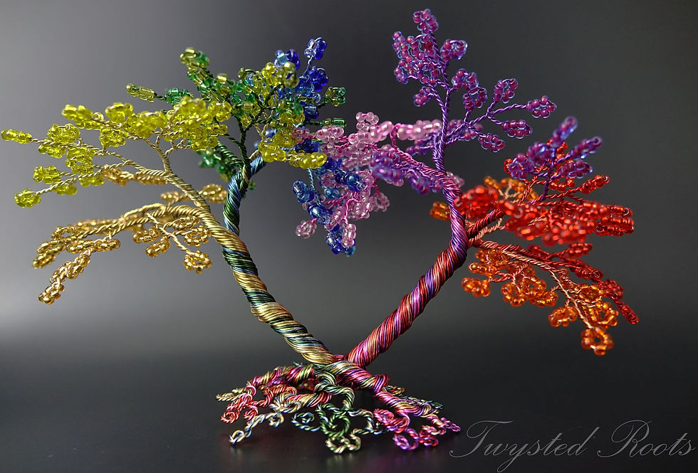 Rainbow coloured bead and wire tree with gold and greens on the left with purple pink orange and red on the right