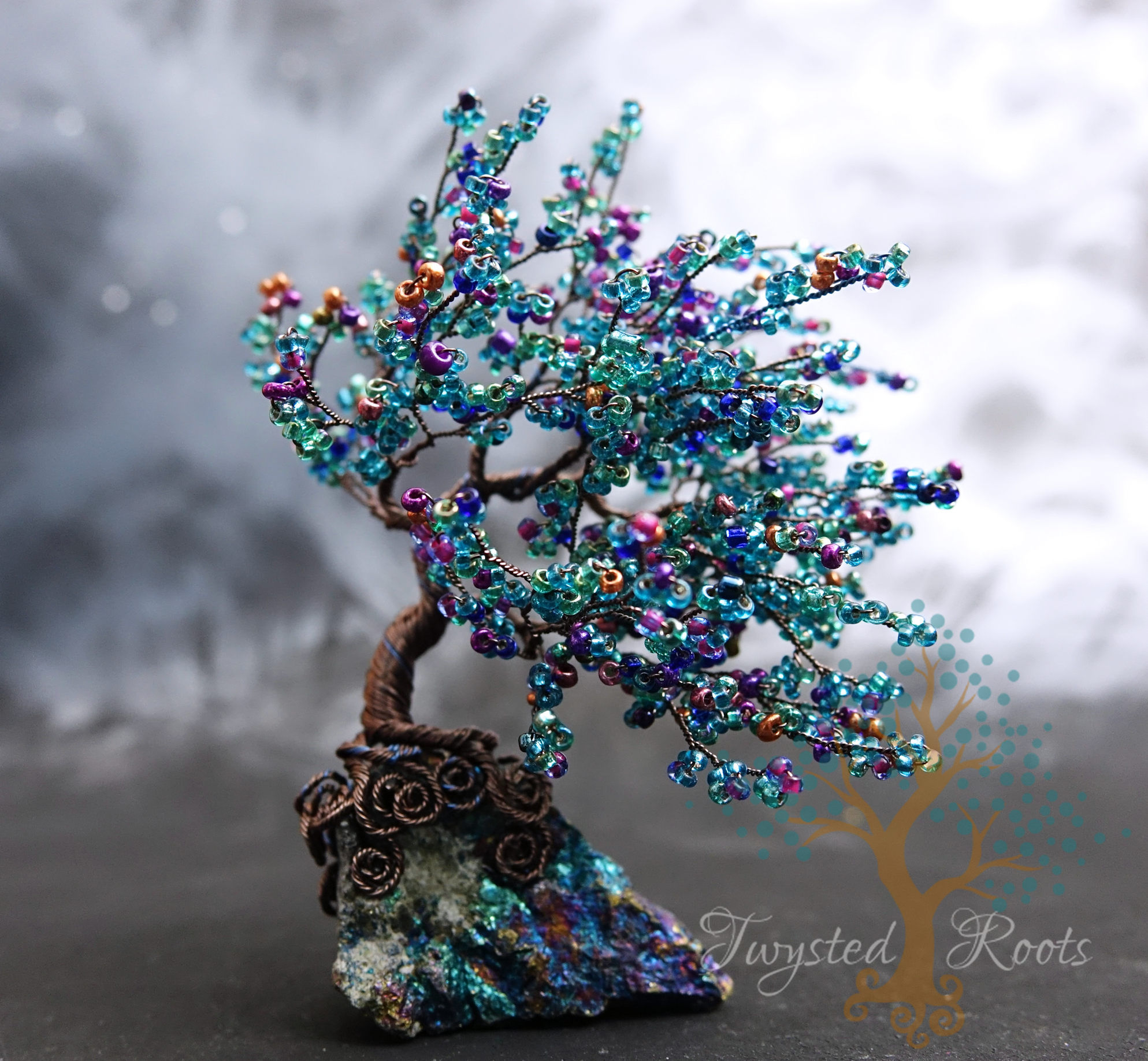 Teal coloured bead and wire tree sculpture by Twysted Roots on a peacock ore base