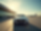 Luxury-car-waits-at-airport-arrivals-terminal-under-sunny-sky..png