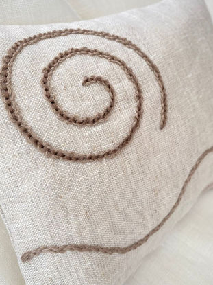 Handmade natural linen tactile cushion with a raised spiral and stitched line