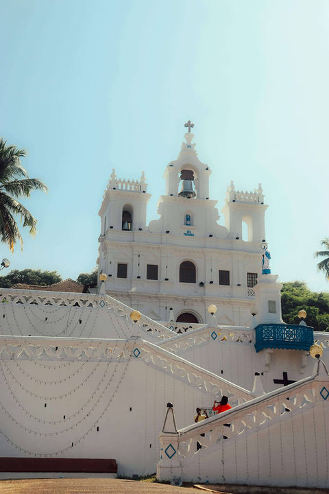 White church building with stairs and blue sky Beera Homes Goa