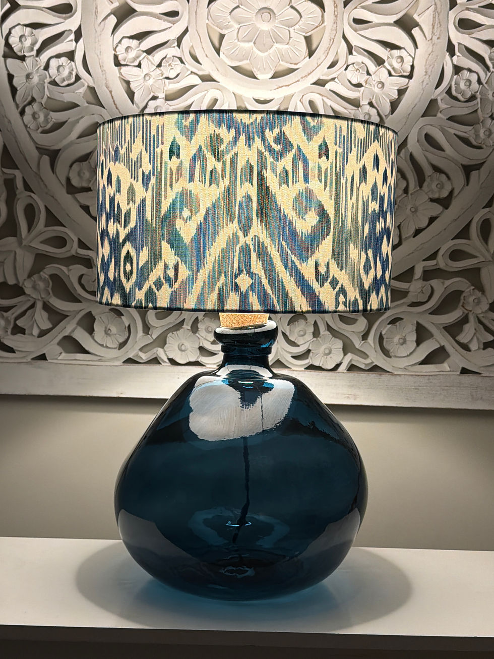 Thumbnail: decorative navy lamp and patterned lampshade set illuminated at night