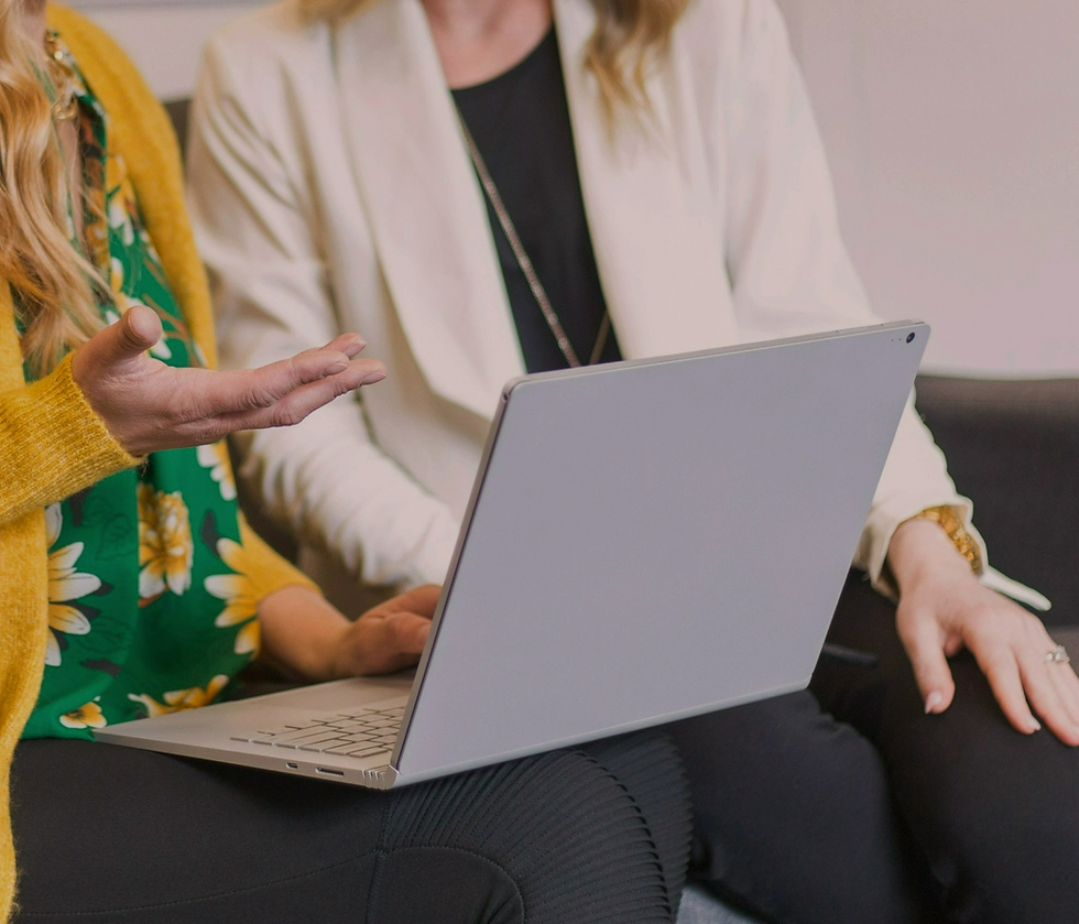 Female PR professionals discussing earned media mentions