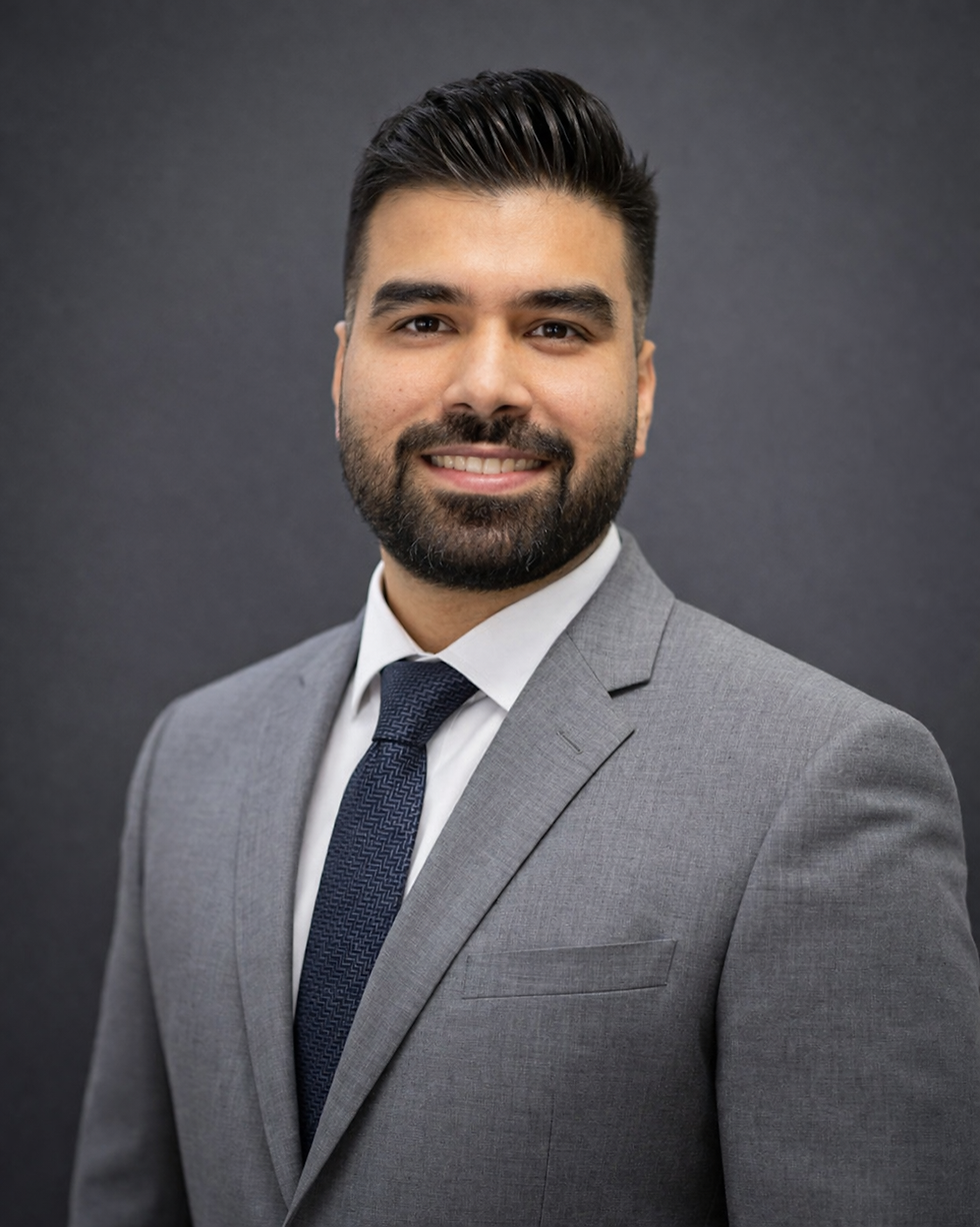 Professional headshot with confident smile.png