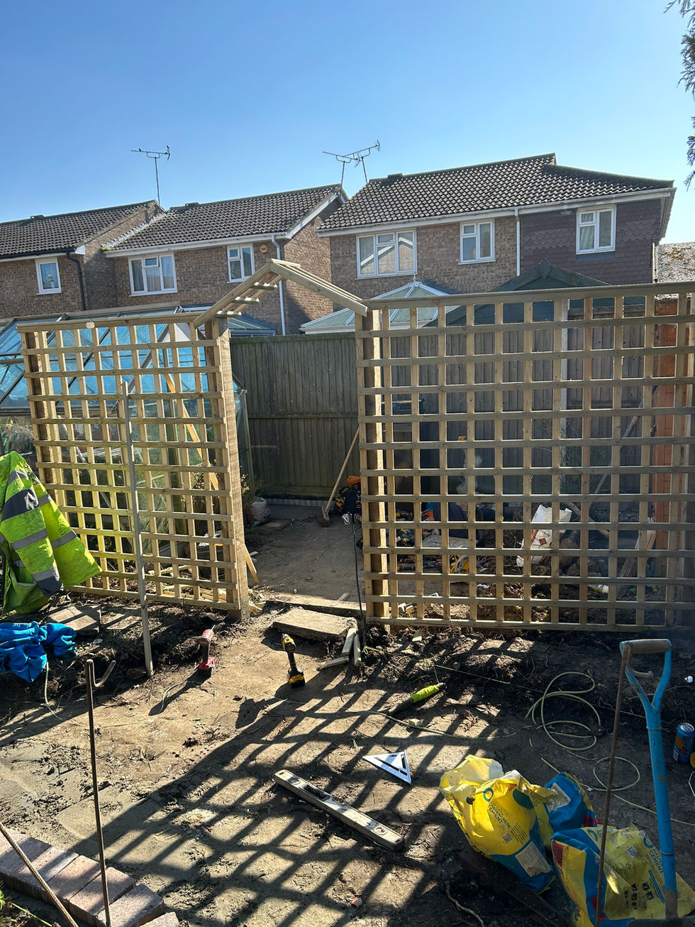 a wooden trellis is being built in a backyard