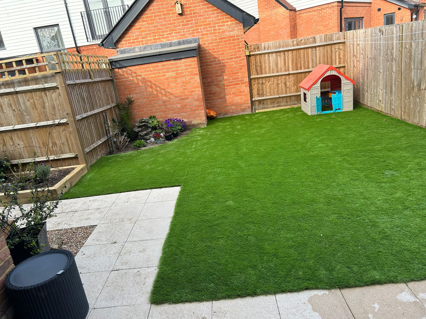 a backyard with a playhouse in the middle of it